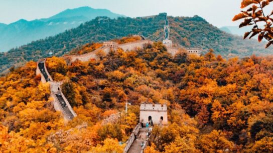 View of mountain, building, stairs and people.