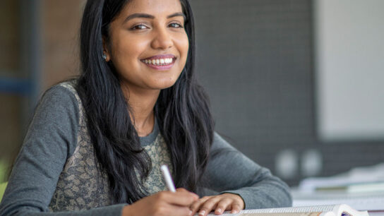 Female student with a smiling face studying.