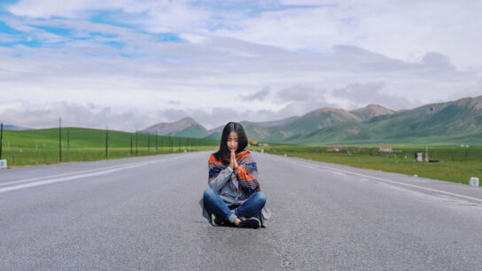 Girl praying on the road.