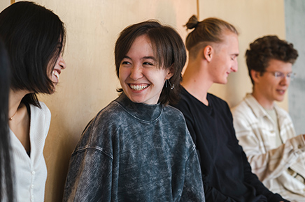 students smiling and laughing during conversation