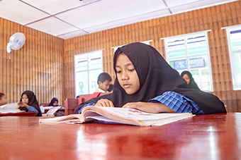 Young child student reading in school