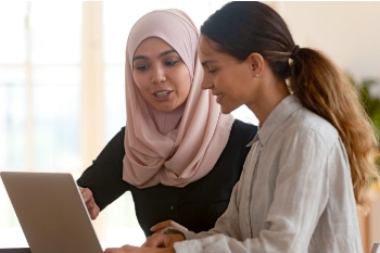 Women learning on laptop together
