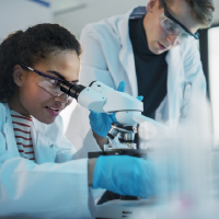 Student using microscope in lab