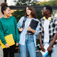 Three students standing and talking
